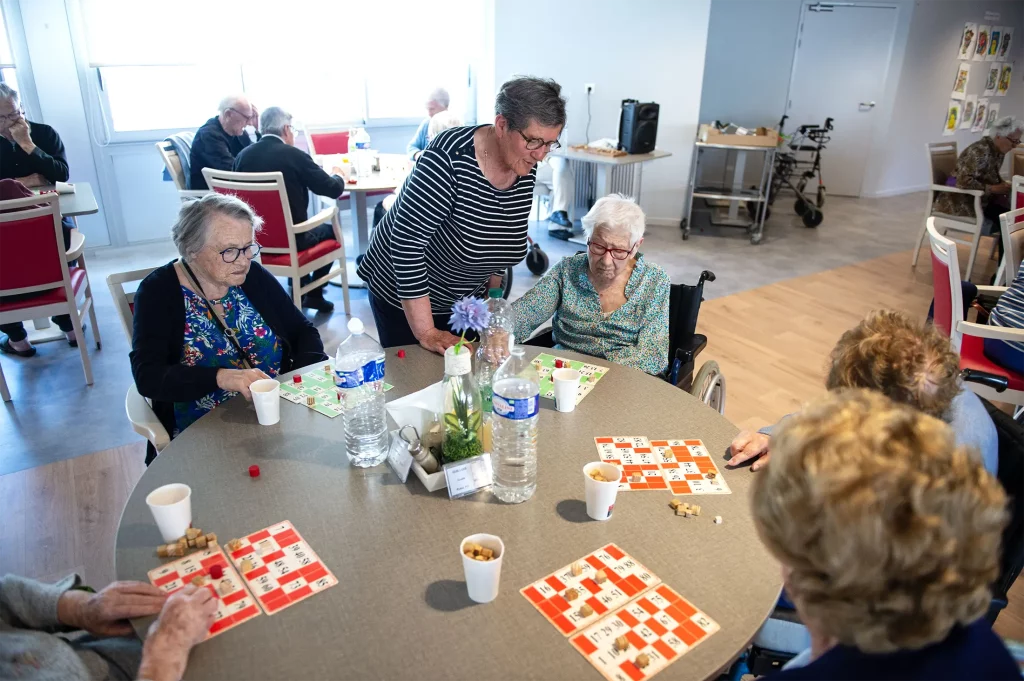 résidents jouant aux jeux de société dans la salle